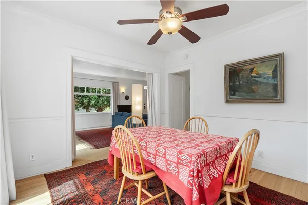 a view of a dining room with furniture and a chandelier