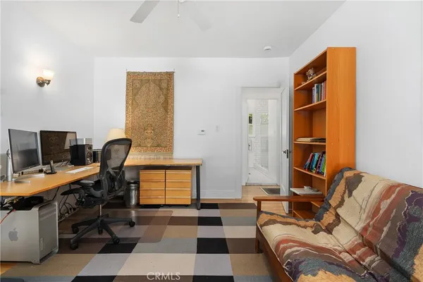 a view of a workspace with furniture and a window
