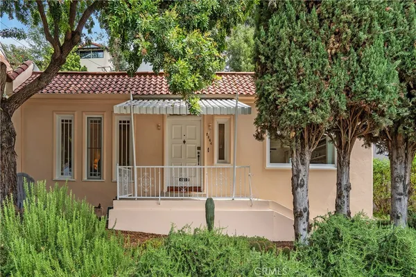 a house with a tree in front of it