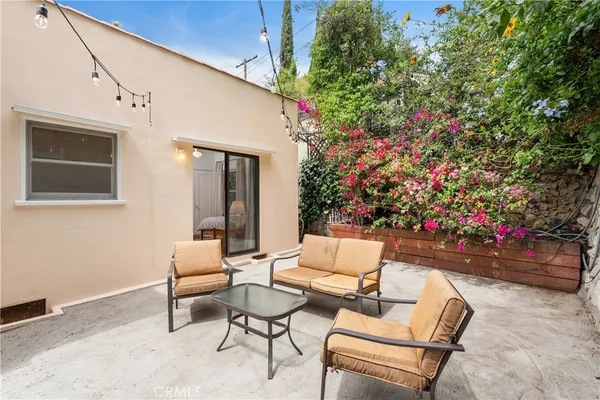 a backyard of a house with table and chairs