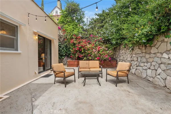 a backyard of a house with outdoor seating
