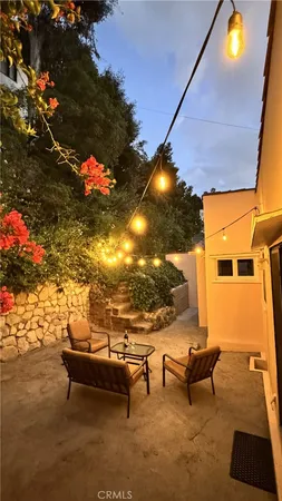 a view of a chairs and table in the back yard