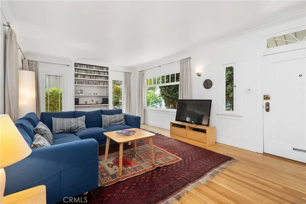 a living room with furniture and a lamp
