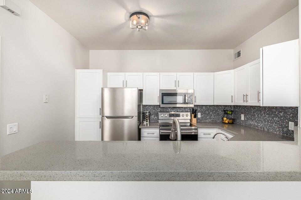 9550 East Thunderbird Road, Unit 266 Scottsdale, AZ 85260 - Photo 12 of 35 a kitchen with stainless steel appliances a refrigerator a stove a sink a counter top space and cabinets