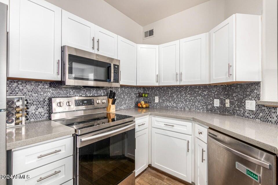 9550 East Thunderbird Road, Unit 266 Scottsdale, AZ 85260 - Photo 13 of 35 a kitchen with cabinets stainless steel appliances and a sink