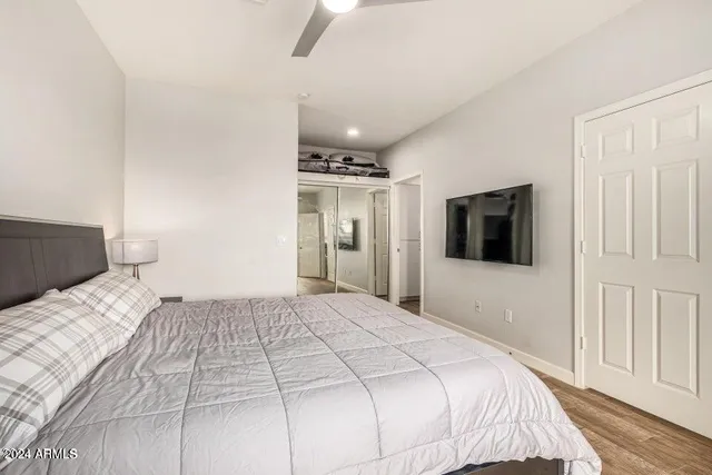 a bedroom with a large bed and a chandelier