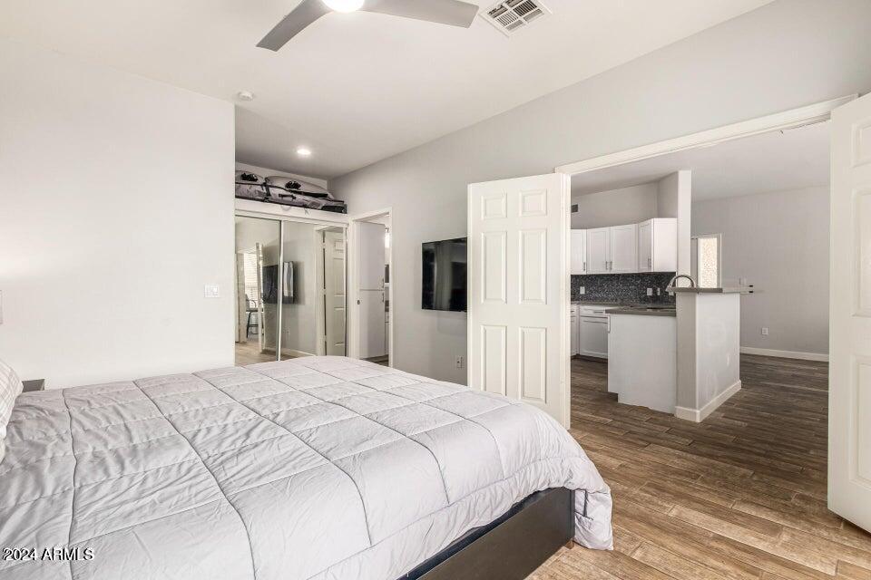 9550 East Thunderbird Road, Unit 266 Scottsdale, AZ 85260 - Photo 18 of 35 a bedroom with a bed and a view of kitchen