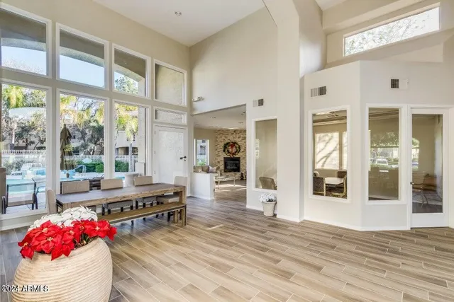 a living room with furniture and large windows