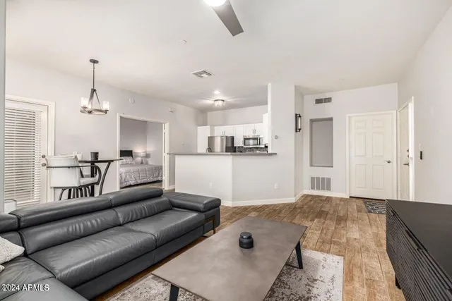 a living room with kitchen island furniture and a kitchen view