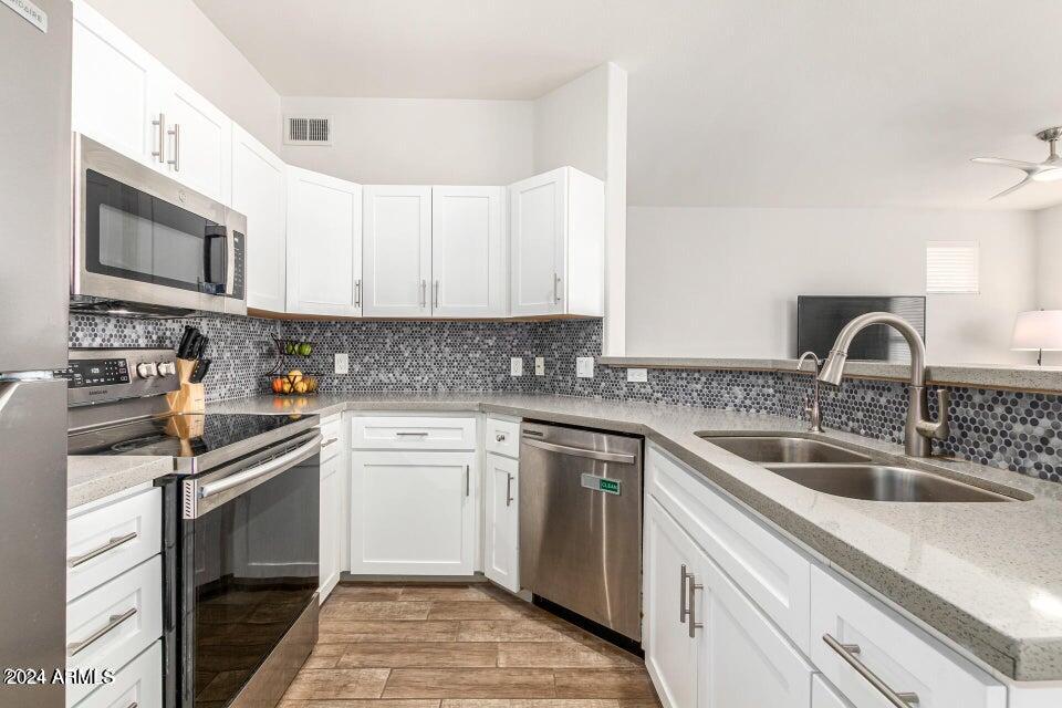9550 East Thunderbird Road, Unit 266 Scottsdale, AZ 85260 - Photo 9 of 35 a kitchen with stainless steel appliances granite countertop a sink and stove top oven