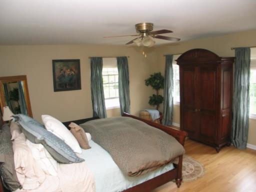 170 North Valley Road Barrington, IL 60010 - Photo 7 of 8 a bedroom with a bed and a chandelier