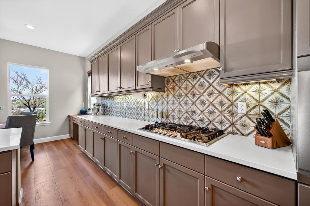 2208 Raintree Court Rocklin, CA 95765 - Photo 11 of 46 a kitchen with stainless steel appliances granite countertop a sink stove and cabinets