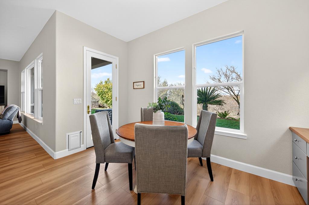 2208 Raintree Court Rocklin, CA 95765 - Photo 14 of 46 a view of a dining room with furniture window and wooden floor