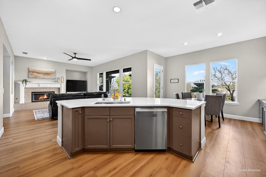 2208 Raintree Court Rocklin, CA 95765 - Photo 15 of 46 a kitchen with a sink cabinets and wooden floor