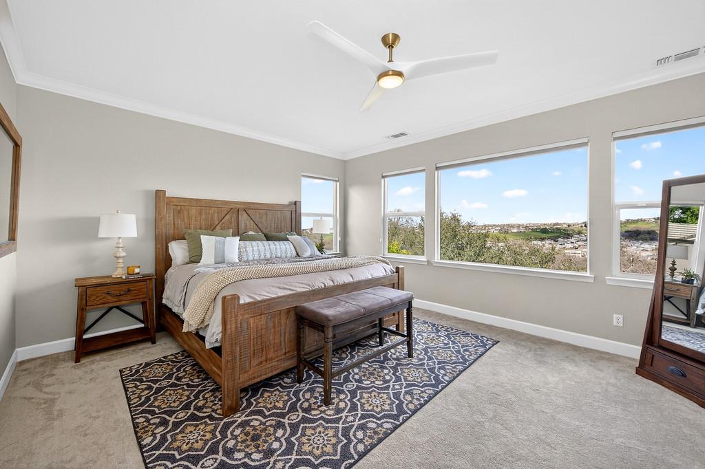 2208 Raintree Court Rocklin, CA 95765 - Photo 24 of 46 a bedroom with a bed lamps and window