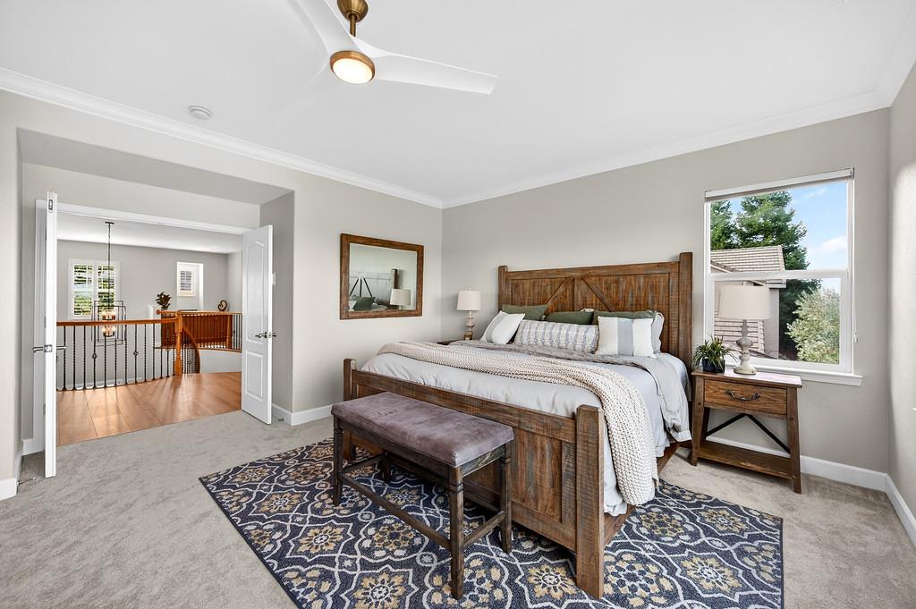 2208 Raintree Court Rocklin, CA 95765 - Photo 25 of 46 a bedroom with a bed a table and chair