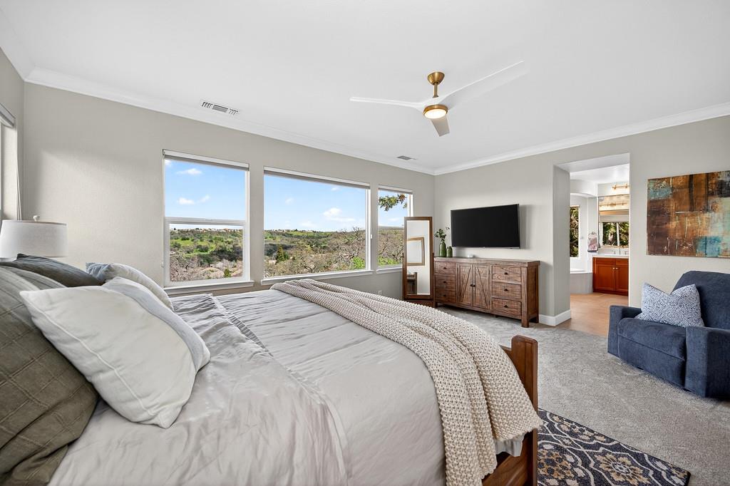 2208 Raintree Court Rocklin, CA 95765 - Photo 26 of 46 a bedroom with a bed flat screen tv and a large window