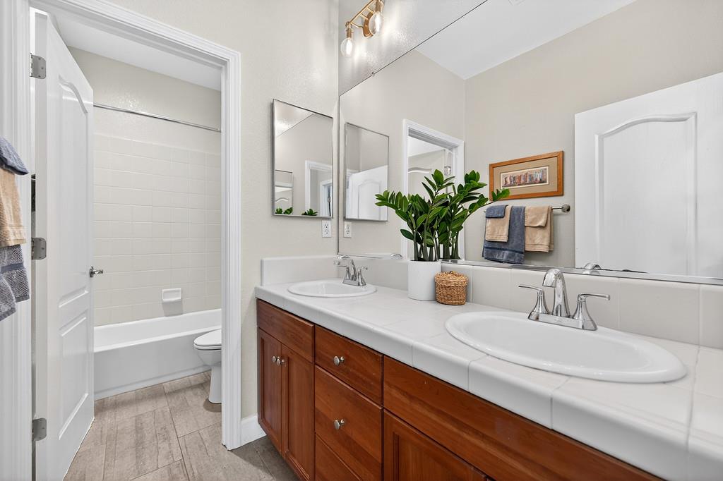 2208 Raintree Court Rocklin, CA 95765 - Photo 31 of 46 a bathroom with a double vanity sink toilet and shower