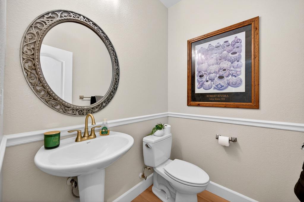 2208 Raintree Court Rocklin, CA 95765 - Photo 32 of 46 a bathroom with a toilet a sink and a mirror