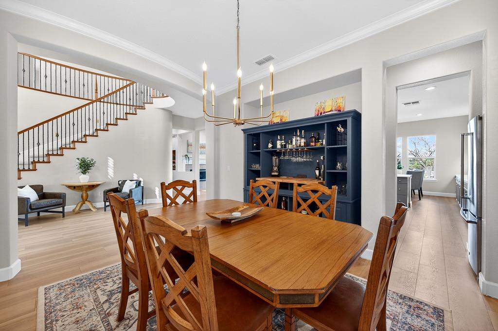 2208 Raintree Court Rocklin, CA 95765 - Photo 8 of 46 a view of a dining room and livingroom with furniture wooden floor a chandelier