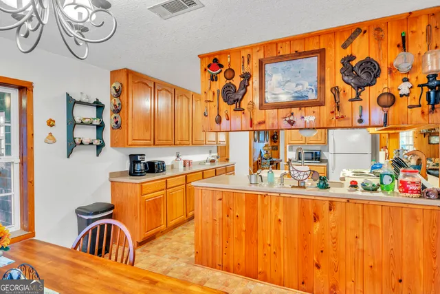 a view of a dry yard with wooden floor and fence