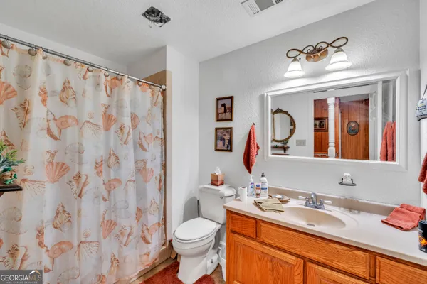 a view of a green field with lots of bushes