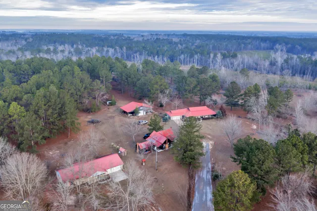 a kitchen with a sink a stove cabinets and a dining table