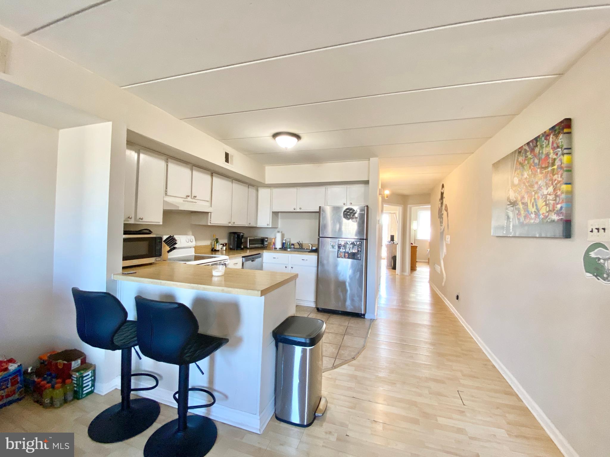 a kitchen with stainless steel appliances granite countertop a sink counter space and a refrigerator