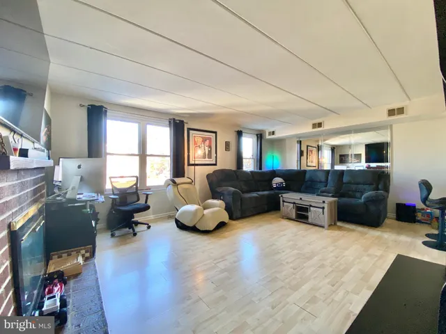 a living room with furniture window and wooden floor