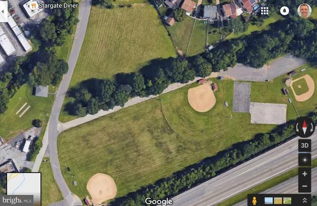 a view of a rooftop deck with chairs and wooden floor