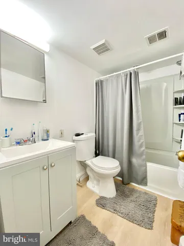 a bathroom with a toilet sink and shower