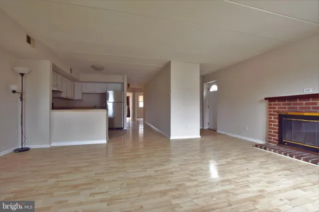 an empty room with windows and closet