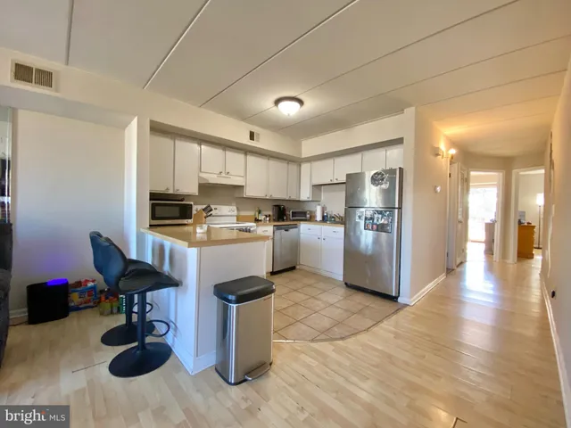 a kitchen with cabinets and chairs