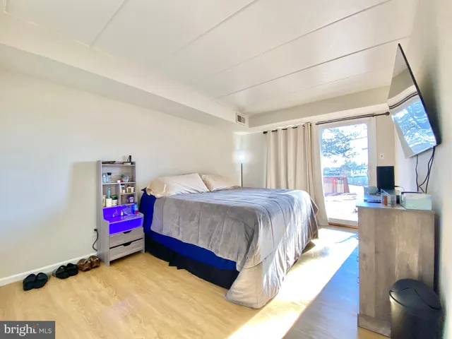 a spacious bedroom with a bed and large windows