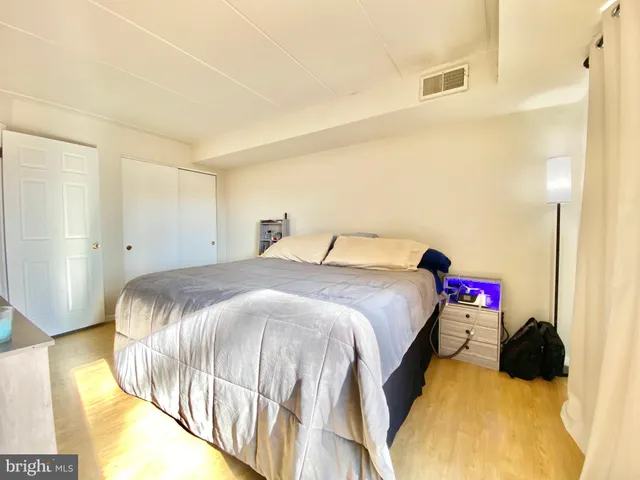 a bedroom with a bed and a couch