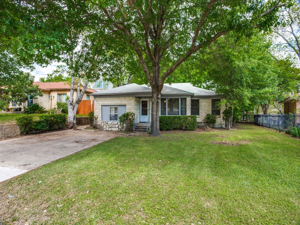 a front view of a house with a yard table and chairs