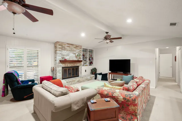a living room with fireplace furniture and a flat screen tv
