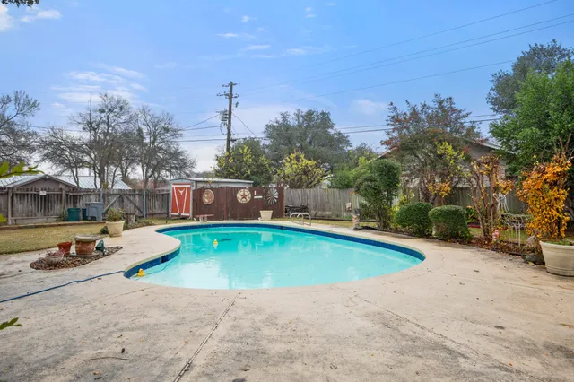 a view of a house with swimming pool and sitting area