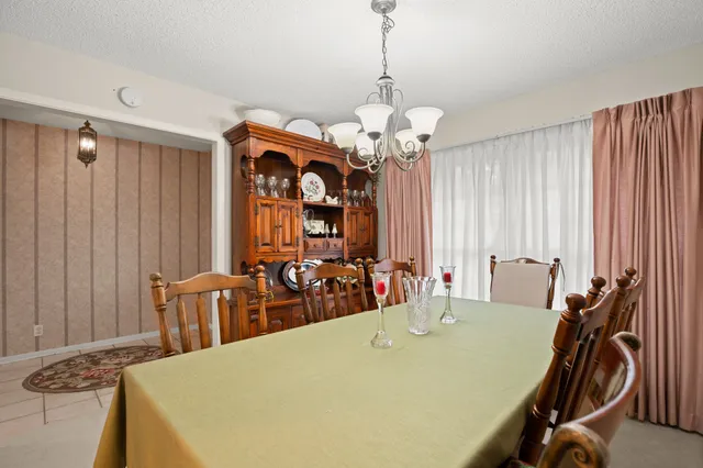 a view of a dining room with furniture and chandelier