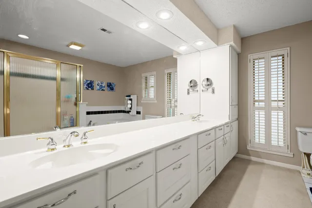 a bathroom with double sink and a large mirror