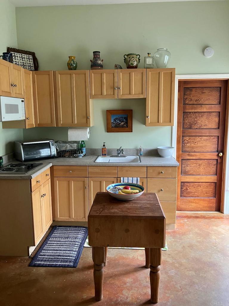18525 Aliso Canyon Road Rancho Santa Fe, CA 92091 - Photo 11 of 16 a kitchen with a sink cabinets and wooden floor