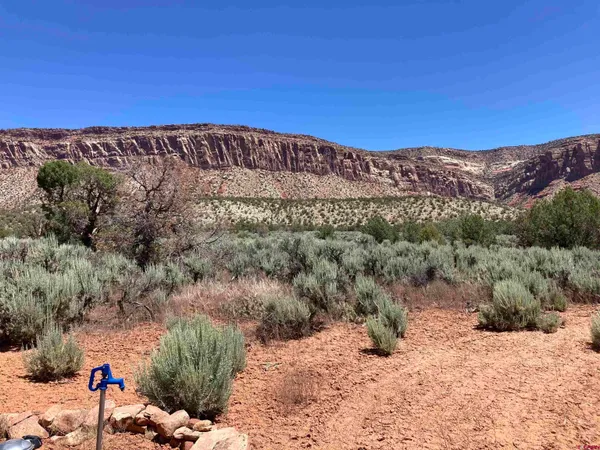 a view of a large mountain with mountains in the background