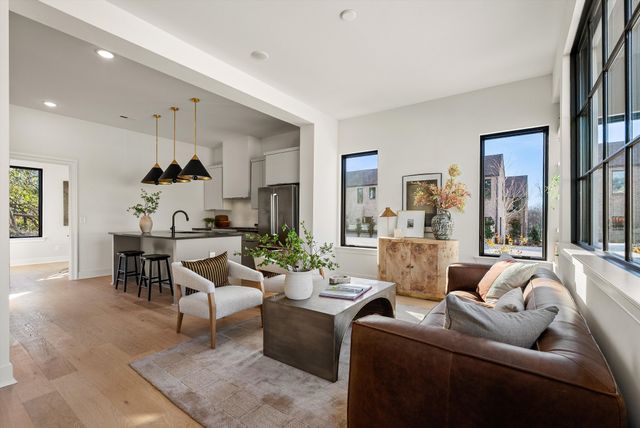 a living room with furniture and large window