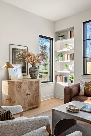 a living room with furniture and a potted plant