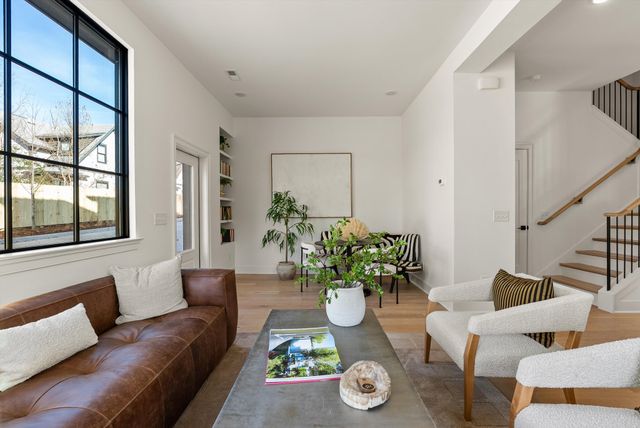 a living room with furniture a table and chairs