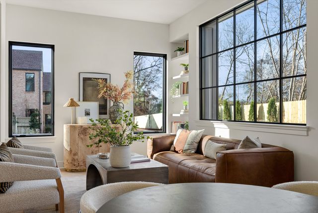 a living room with furniture and a potted plant
