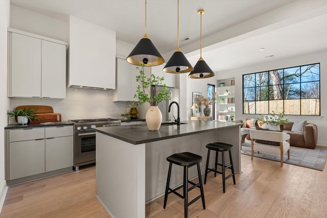 a kitchen with stainless steel appliances granite countertop a stove and a refrigerator