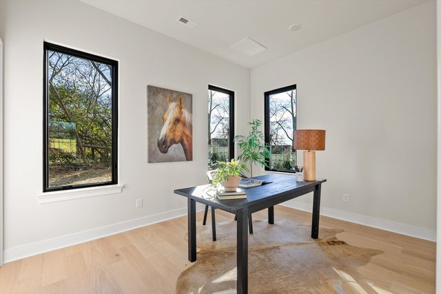 a bathroom with a granite countertop sink mirror vanity and toilet