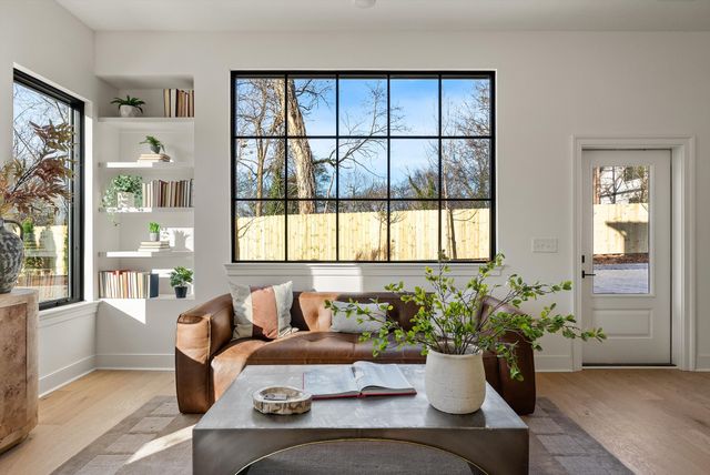a living room with furniture and flowers
