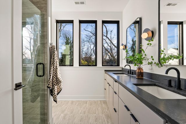 a living room with furniture and a potted plant next to a window